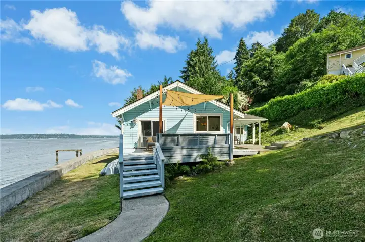 Low-bank waterfront living offering a connection between the home, yard, bulkhead and beach.