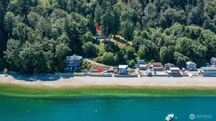 Enjoy the best of both worlds with a secluded waterfront cabin nestled among mature trees and 80 feet of private bulkheaded shoreline on beautiful Tyee Beach.