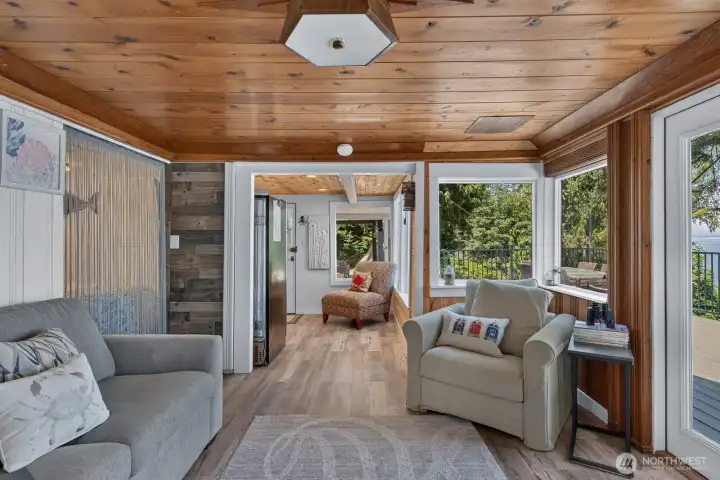 Light-filled living space with timeless wood finishes, luxury vinyl plank flooring, and water views from nearly every angle.