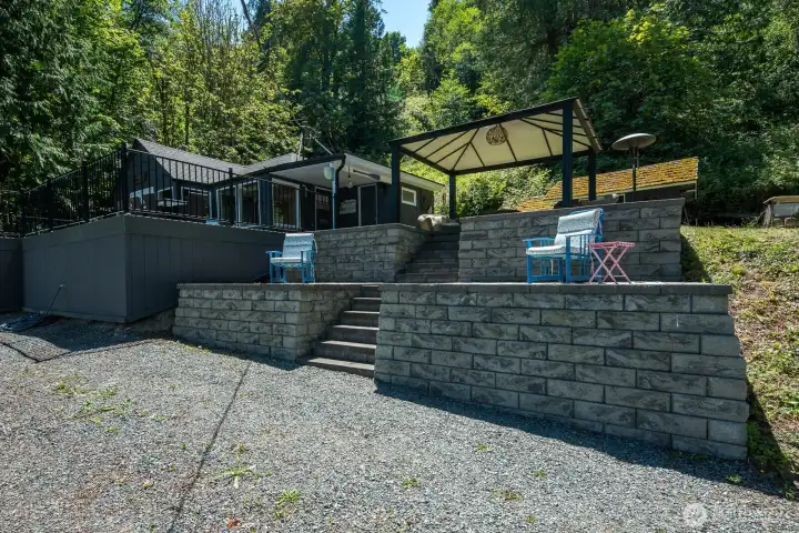Beautiful terraced outdoor living areas feature spacious patios, a covered cabana, and easy access to the expansive deck above.