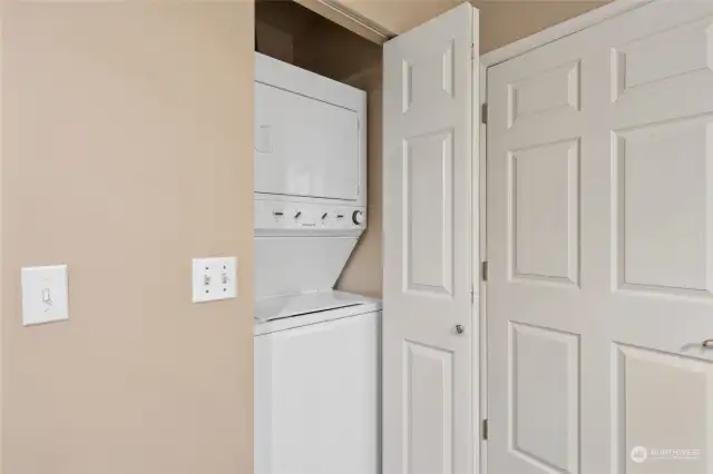 Stacked washer and dryer in the bathroom closet.