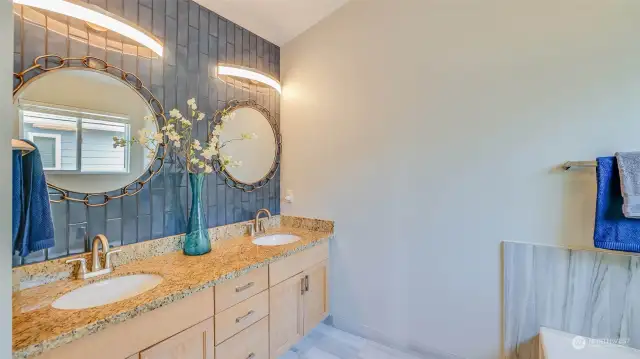 The 5-piece primary bath has been updated with new flooring, granite counters and a glass surround shower.