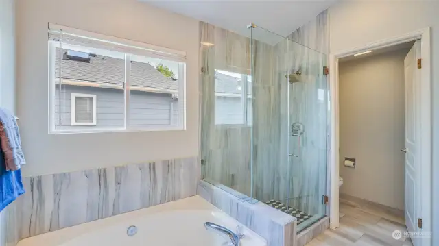 The primary bath also has a peaked ceiling and wonderful use of gorgeous tile.