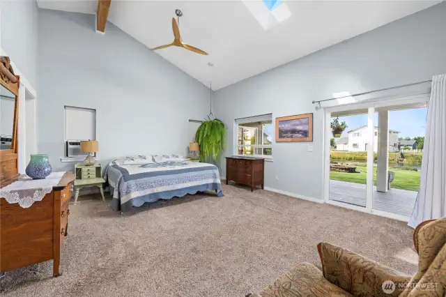 This primary suite w/lake views is spacious, bright & comfortable! Walk out to the covered deck with yard & lake access...