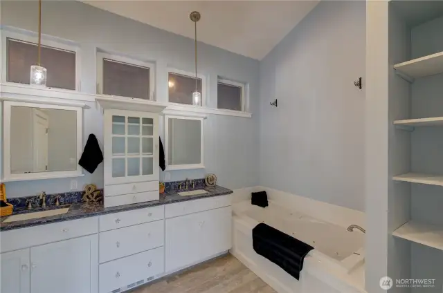 Double vanity, jetted soaking tub, built in shelving...