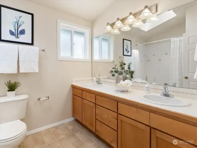 Full bathroom with a tub/shower, and lots of natural lights. Photo shows Unit B (MLS 2276317) with reversed identical floor plan.