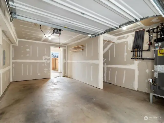 1-car attached garage with plenty of storage. Photo shows Unit B (MLS 2276317) with reversed identical floor plan.