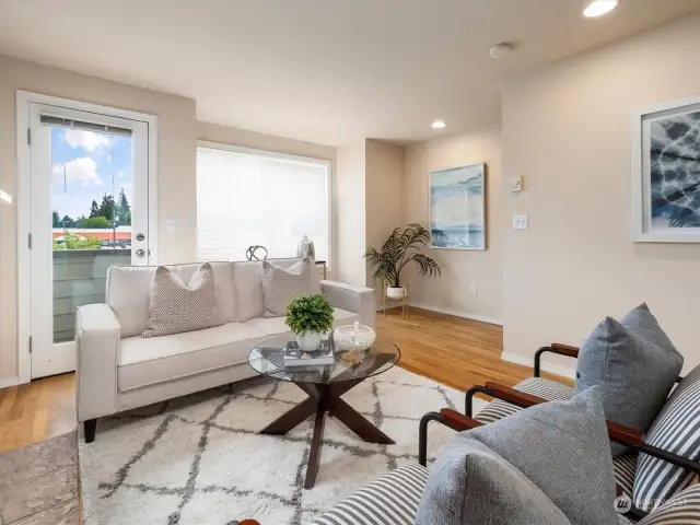 Bright and cozy living room with a gas fireplace and a balcony with territorial views. Photo shows Unit B (MLS 2276317) with reversed identical floor plan.