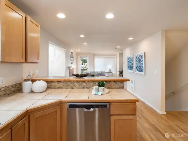 Spacious kitchen with a pantry closet, breakfast bar, and gas range. Photo shows Unit B (MLS 2276317) with reversed identical floor plan.