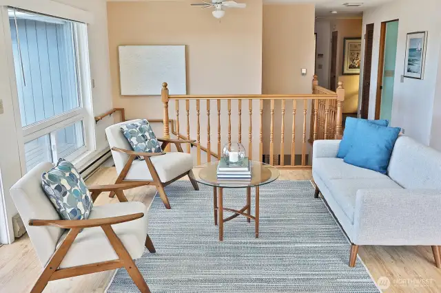Natural light flood the living, dining, and kitchen areas.