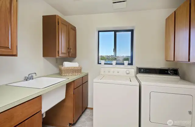 Laundry room includes a large sink.
