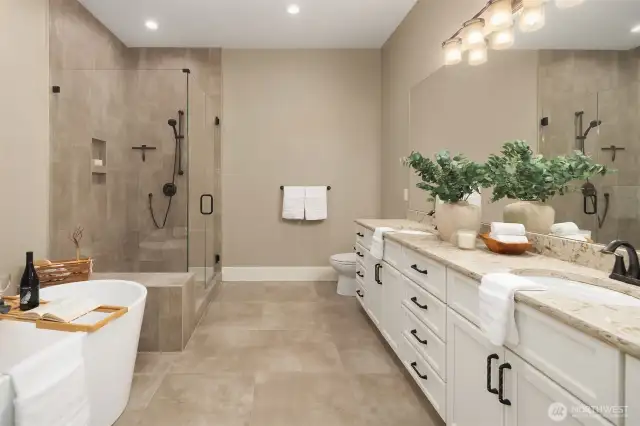 Main level Primary bath with large soaking tub, dual vanities and large shower.