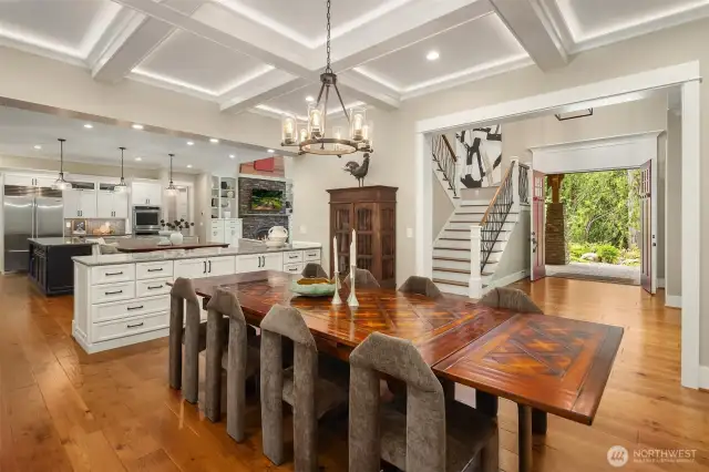 Dining room features coffered ceiling detail and views to the backyard sanctuary.