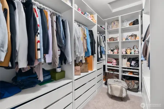 Expansive walk-in closet with custom built-in storage!