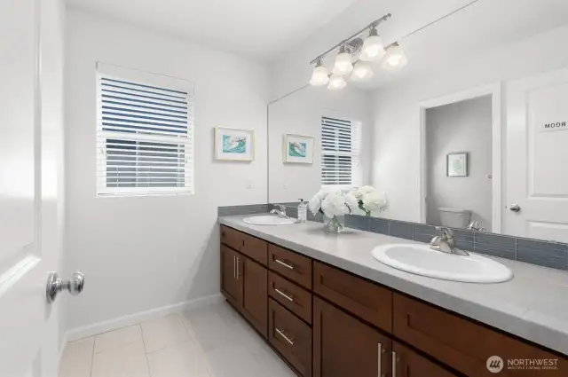 The upstairs full bathroom features a double sink vanity + a separate tub/shower and toilet room!