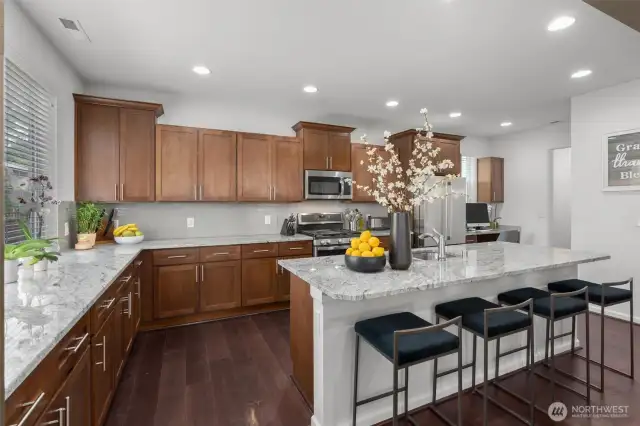 Step into this beautifully designed chef’s kitchen, where style meets functionality. Featuring rich wood cabinetry, sleek stainless steel appliances, and gleaming granite countertops!