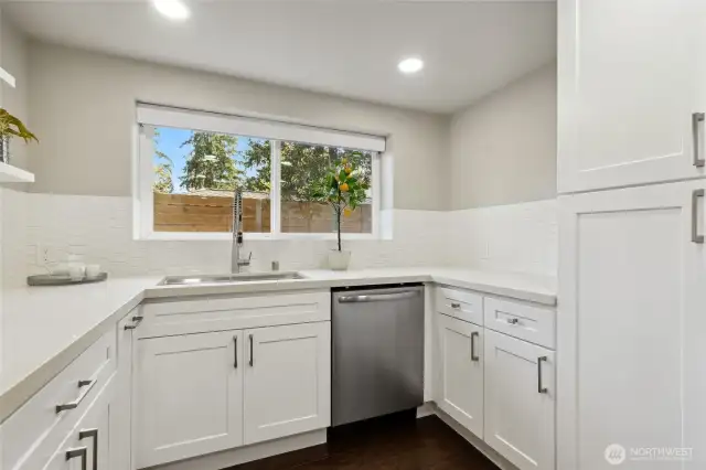 Lower-level kitchen with SS dishwasher