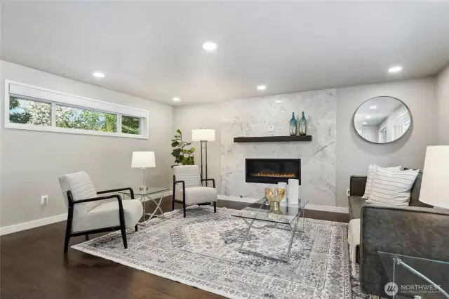 Cozy great room living space with contemporary horizontal gas fireplace insert and remote-control operation...
