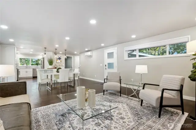 Open floor plan featuring a chef's kitchen, quartz counters, stainless steel appliances, & engineered hardwoods...