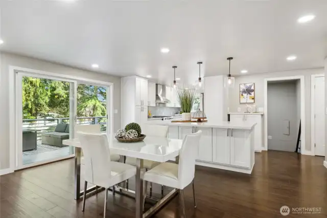 View from the great room to the dining area and sliding door to the deck. Perfect for entertaining. Enjoy the oversized deck overlooking the professionally landscaped backyard....