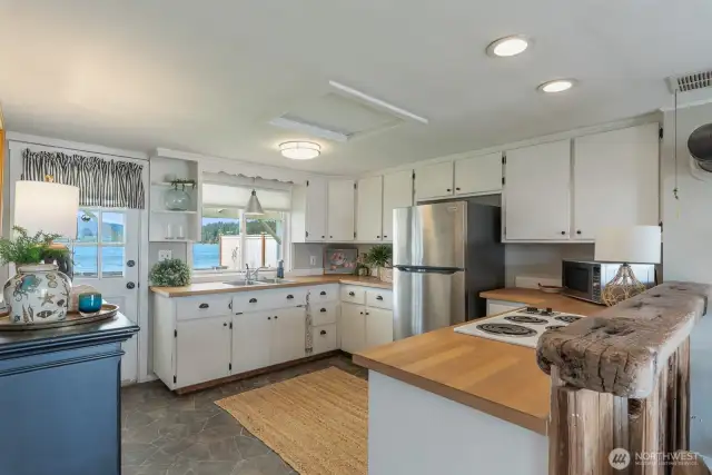 Nice sized kitchen with lots of storage and counter space.  Door leads out to the back yard.