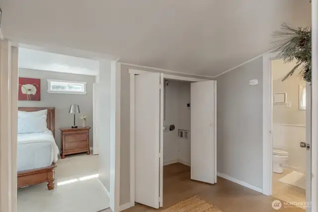 Barn door leads to the Bedroom that is big enough for a king bed and has a large walk in closet. There is so much storage for a small cabin, possibilities are endless!! Closet for washer and dryer with more storage.