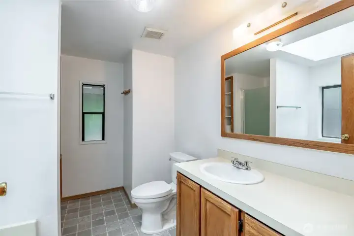 Primary ensuite with soaking tub and walk-in shower.