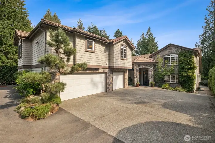 The main house is the one closer to the river and the apartment is above the 3-car garage on the left.
