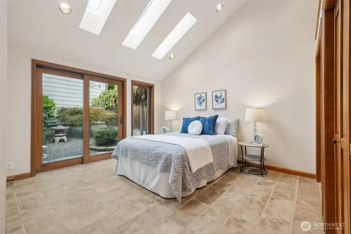 Main floor guest room leads to patio & small courtyard.
