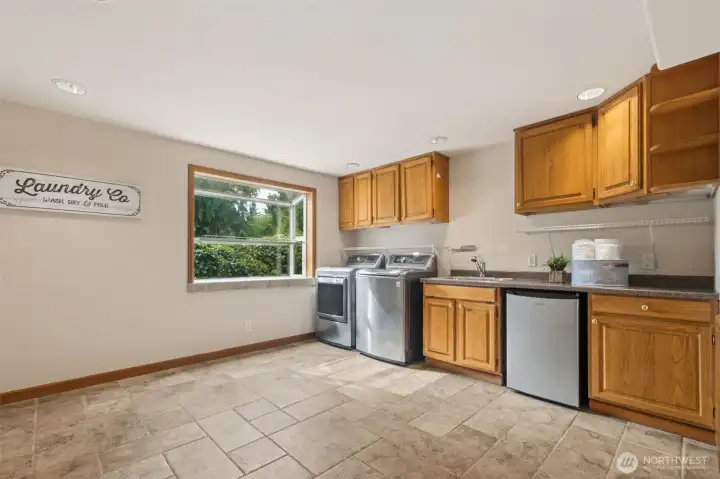 Huge laundry room with tons of cabinets & counters, plus sink -- can double as walk-in pantry with shelving units on the opposite wall. Washer & Dryer AND mini-fridge included!
