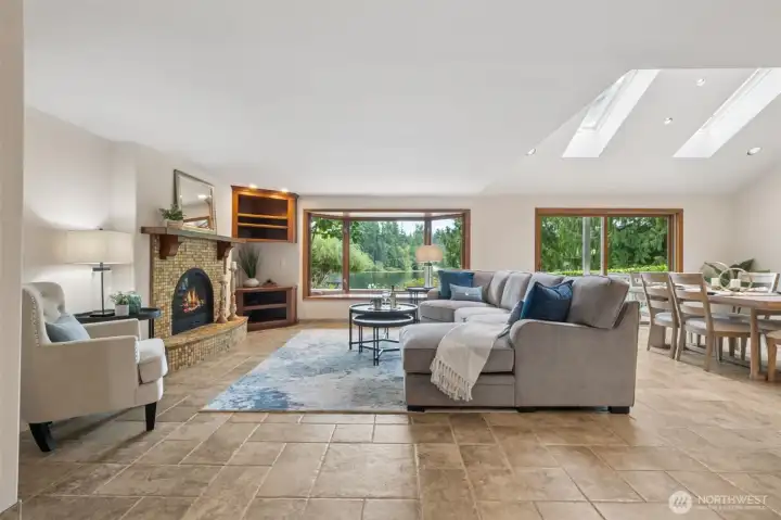 The expansive windows let the lake shine in! In the winter you'll appreciate the hydronic heated floors and the cozy gas fireplace.