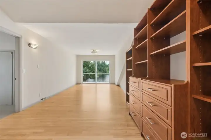 Open area on upper floor leading to balcony looking out on the lake.