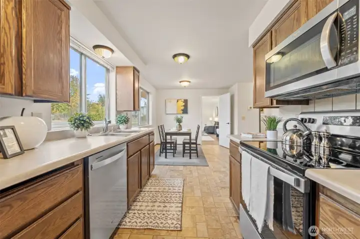 The kitchen is an entertainer's delight! It features solid wood cabinets, electric range, hard surface countertops, a stainless steel appliance package and easy-care flooring.