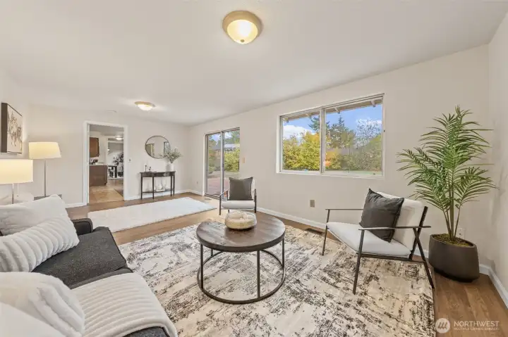 The family room connects seamlessly to the kitchen and casual dining area through a nearby door, creating an open layout ideal for daily living or entertaining. Clear sight lines enhance the flow and functionality of the space.
