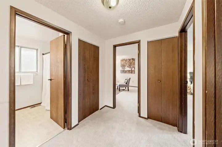 The upper-level hallway guides you to the additional bedrooms, a full guest bathroom, and the secluded Primary Suite tucked at the end—offering a functional layout that balances shared and private spaces   beautifully.