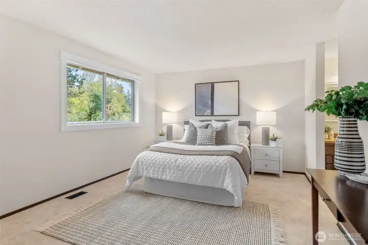 Welcome to the Primary Suite! You've found the perfect place to come and unwind! The large picture window frames the back garden and allows ample natural light in when you want it. Notice the wood wrapped window for extra detail.