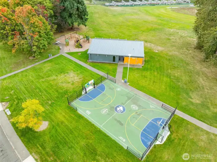 This public park includes a full basketball court, modern playground, and on-site restrooms. Surrounded by open green space, it's designed for both play and relaxation.