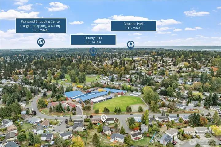 Conveniently located near schools, parks, and shopping, this home offers easy access to Tiffany Park (0.3 miles), Cascade Park (0.6 miles), and Fairwood Shopping Center (2.1 miles). Aerial view highlights the neighborhood’s walkability and surrounding amenities.