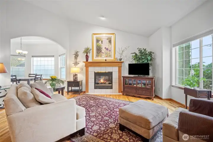 Inside you a greeted with a bright living room with vaulted ceilings & cozy fireplace