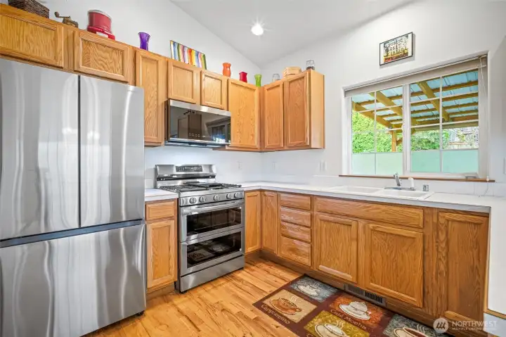 Well-appointed kitchen featuring warm wood cabinetry, stainless steel appliances, and abundant counter space.