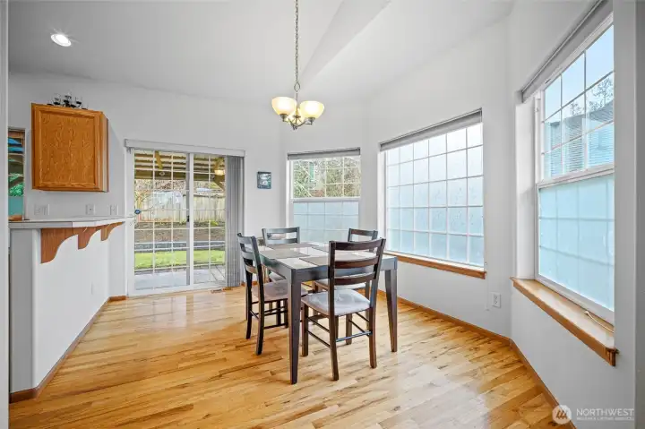 Imagine having your morning coffee at this sunny kitchen table surrounded by windows.