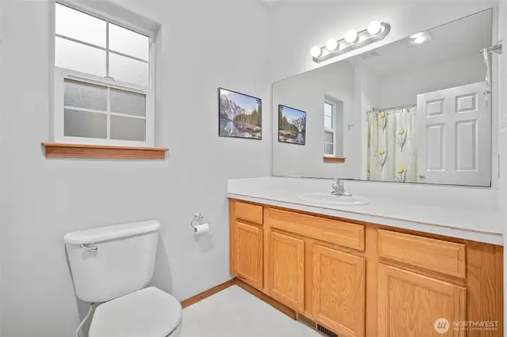 Primary bath with full size tub/shower combo.