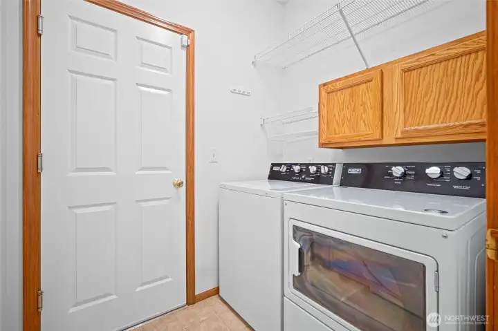 Laundry room with extra storage. There is another closet not shown to the left of this photo.