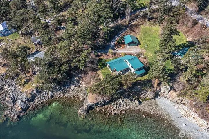 This waterfront estate sits at the water's edge overlooking Eastsound Village to the north and East Sound Bay to the south. Bookended by two beaches and ownership of the tidelands