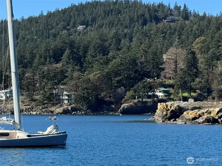 This photo was taken across Eastsound Bay looking towards the property from the County public dock. The property enjoys a mooring buoy in front of the house, seen across the bay (white ball). Protected Indian Island sits proudly to right, accessed on foot at low tide.
