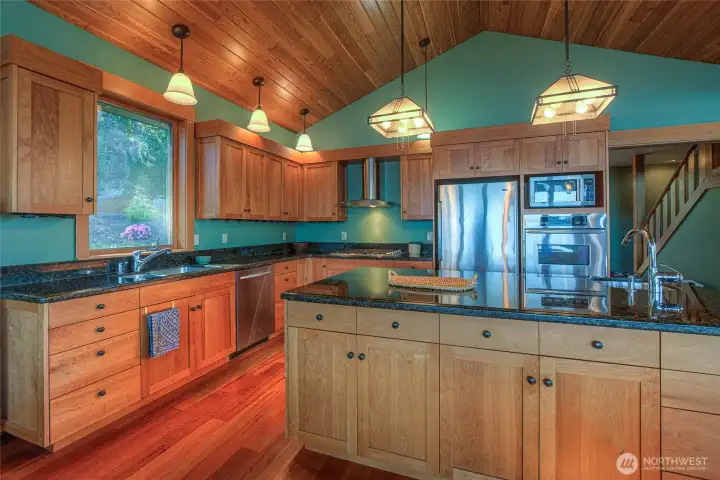 A cook's delight!!! This kitchen boasts custom cabinetry, vaulted ceiling and plenty of counter space for whatever you intend to create in this dream space.