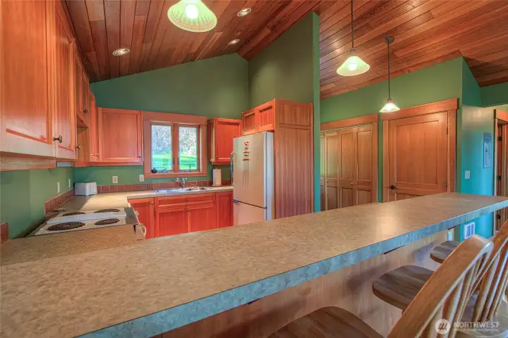 Custom fir cabinets and open floor plan allows for quiet meals or entertaining. Plenty of storage and lighting throughout.