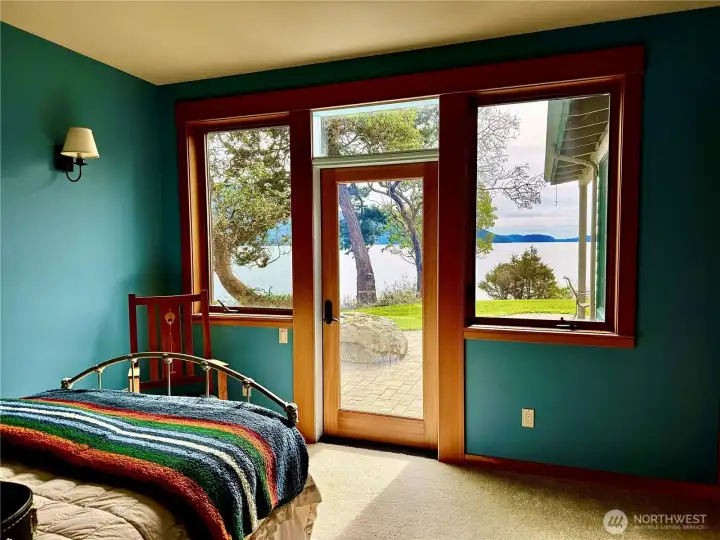 Guest house bedroom faces south overlooking Easts Sound Bay. Access to outdoor patio area.