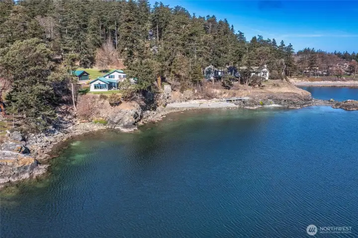 This photo shows the entire waterfront of the two parcels offered for sale. Neighbor's house to the right of this frame owns a portion of the beach in front.