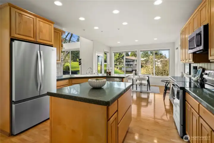 Open kitchen with sitting area. New stainless appliances.